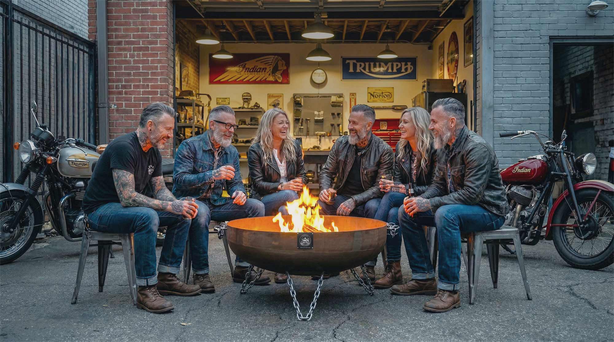 A group of middle-age friends sitting around a heavy duty Fire pit